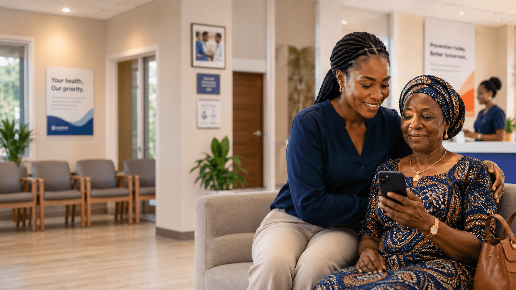 A care companion and older woman reviewing a health plan on a phone inside a clinic.